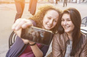 Girls Taking Selfie Seated at Bar