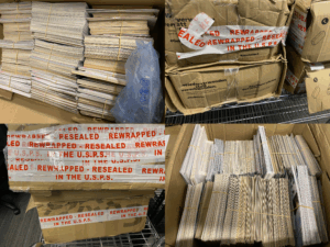 A four-panel collage shows battered cardboard boxes marked “REWRAPPED – RESEALED IN THE U.S.P.S.” sitting on a metal cart. Inside, neat stacks of rubber-banded 4×6 prints fill each carton wall-to-wall. A single blue air-cushion pouch hints at careful packing. A four-panel collage shows battered cardboard boxes marked “REWRAPPED – RESEALED IN THE U.S.P.S.” sitting on a metal cart. Inside, neat stacks of rubber-banded 4×6 prints fill each carton wall-to-wall. A single blue air-cushion pouch hints at careful packing.