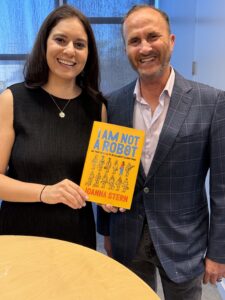 Joanna Stern holding her book I Am Not a Robot with Mitch Goldstone after a Live Talks Los Angeles discussion about AI, technology, privacy, and family photos.