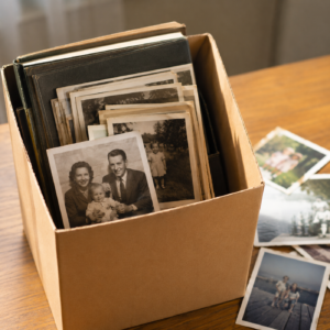 Box of inherited family photos and albums awaiting preservation during an estate cleanout. Box of inherited family photos and albums awaiting preservation during an estate cleanout.